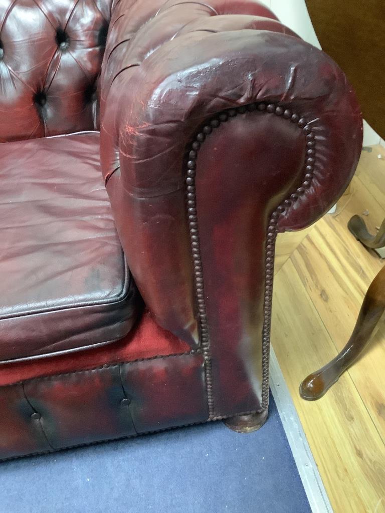 A Victorian style buttoned burgundy leather Chesterfield settee, width 206cm depth 88cm height 70cm